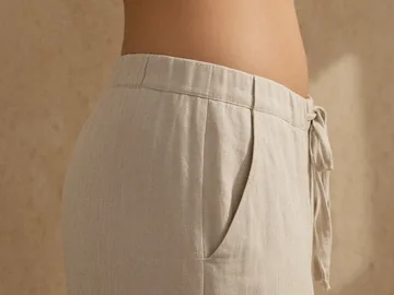 The side of a hip above oatmeal linen pants